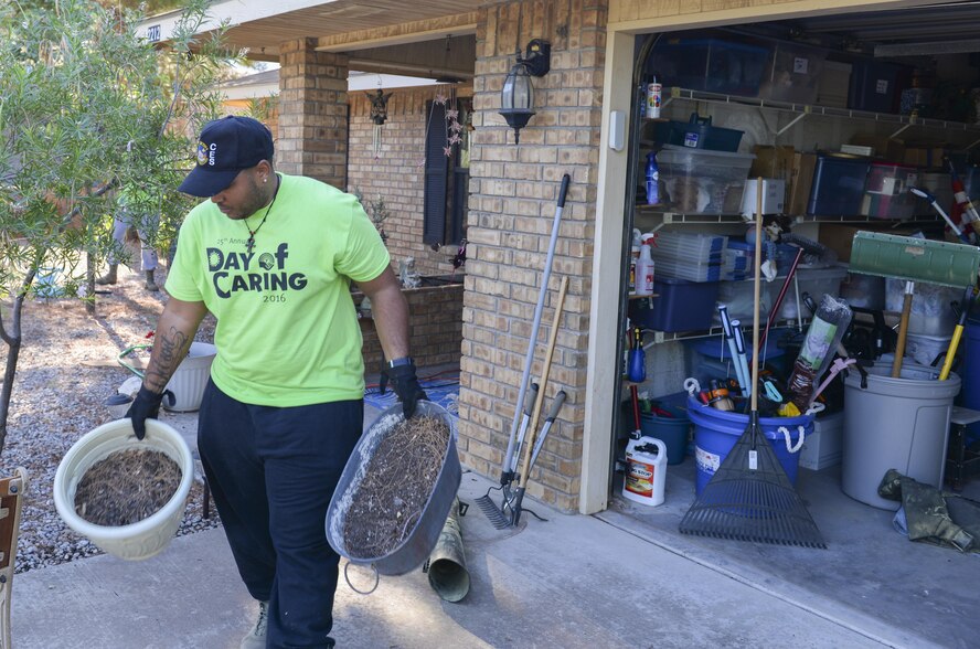 Senior Airman Ervin, a Day of Caring volunteer, and a heating, ventilation and air conditioning technician with the 49th Civil Engineer Squadron here, removes two flower pots from a disabled resident’s front lawn in Alamogordo, N.M. on Sept. 9, 2016. The annual Day of Caring was an all-day volunteer event and employed the help of hundreds of Holloman Airmen. (Last names are being withheld due to operational requirements. U.S. Air Force photo by Airman Alexis P. Docherty)
