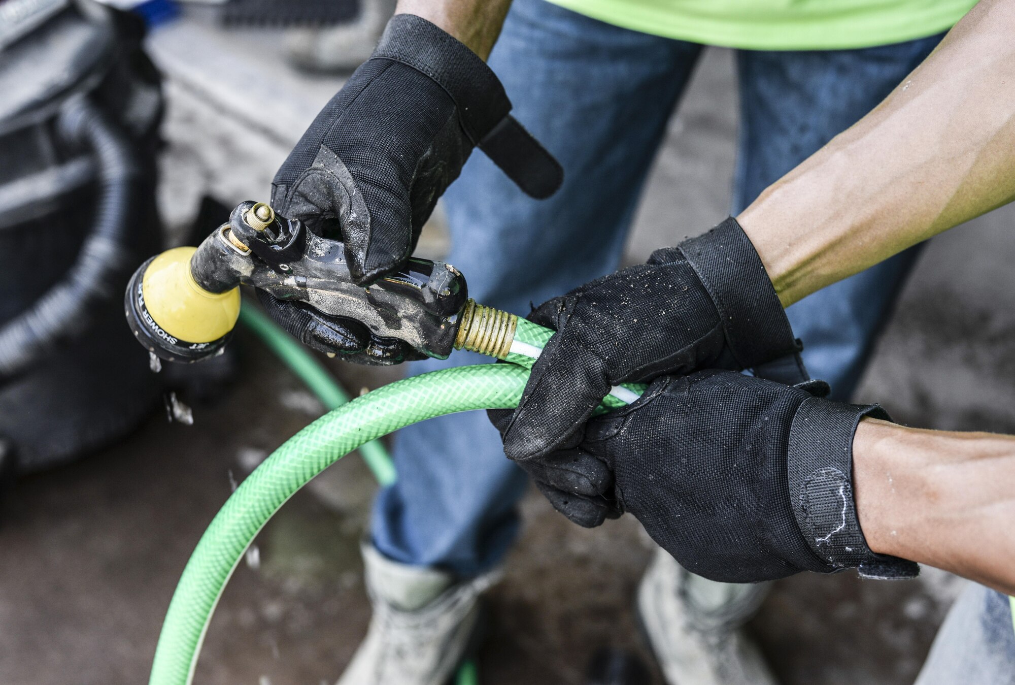 Two Day of Caring volunteers fix a disabled resident’s watering hose in Alamogordo, N.M. on Sept. 9, 2016. Day of Caring volunteers perform daily tasks that may prove difficult for disabled individuals and senior citizens. (U.S. Air Force photo by Airman Alexis P. Docherty)