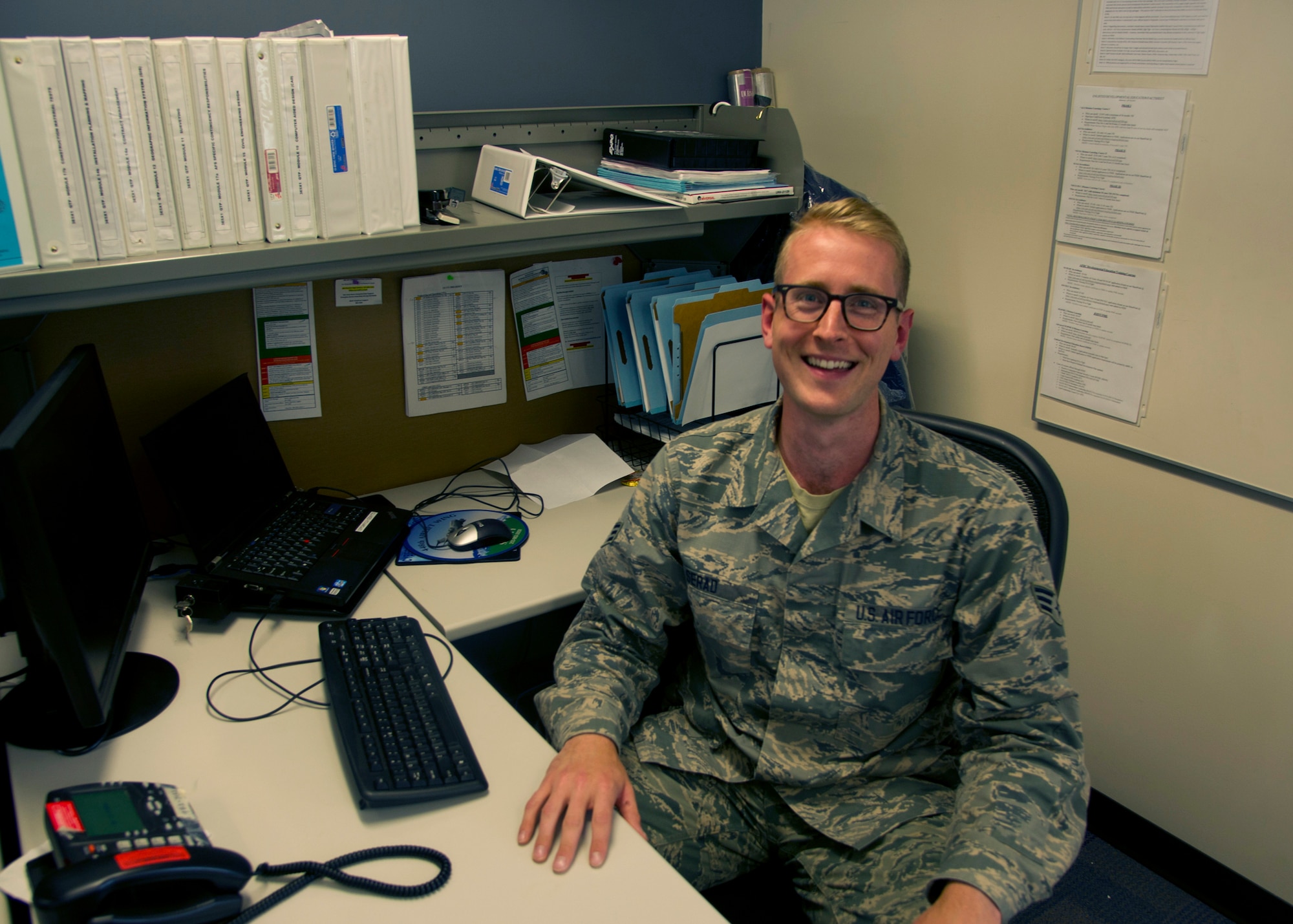 Senior Airman Troy Serad, an engineering assistant with the 446th Civil Engineer Squadron, poses for a photo at his desk Sept. 11, 2016, at Joint Base Lewis-McChord. During Serad’s 10th grade year of high school he was homeless and dropped out of school. Serad eventually went back to school and is currently studying for the entrance exam to law school. (U.S. Air Force Reserve photo by Tech. Sgt. Bryan Hull)