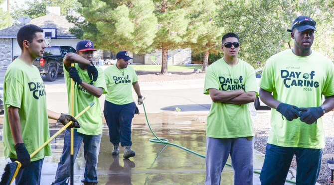 Members of the 49th Civil Engineer Squadron team up to beautify a disabled resident’s front lawn and backyard as part of the annual Day of Caring volunteer event in Alamogordo, N.M. on Sept. 9, 2016. Hollomen Airmen account for a majority of the Day of Caring volunteer event taskforce. (U.S. Air Force photo by Airman Alexis P. Docherty)