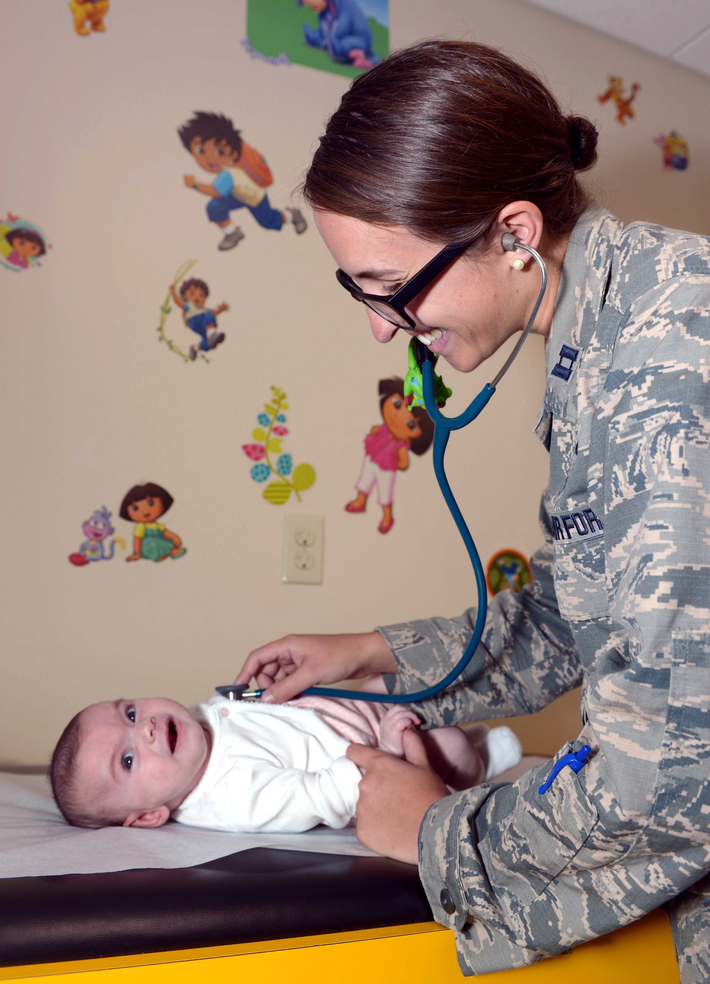 Capt. Megan McDonald, a pediatrician with the 28th Medical Group, performs a check-up on a child at Ellsworth Air Force Base, S.D., Sept. 8, 2016. McDonald graduated from the U.S. Air Force Academy in 2008, and attended medical school at Georgetown University School of Medicine. She later attended pediatric residency training at Dayton Children's Hospital at Wright Patterson Air Force Base, Ohio, the nation's only fully integrated military-civilian residency training program. (U.S. Air Force photo by Airman 1st Class Donald C. Knechtel)