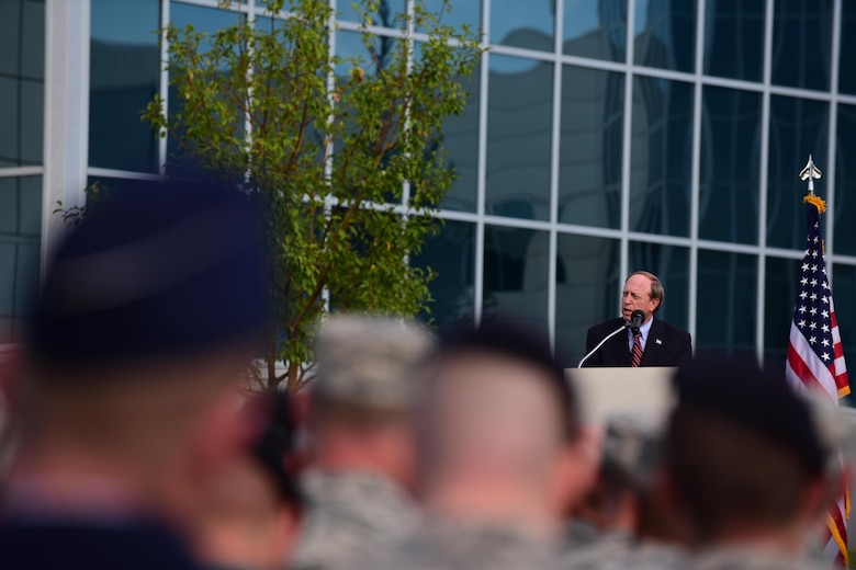PETERSON AIR FORCE BASE, Colo. - John Suthers, Colorado Springs mayor and former Attorney General of Colorado, address the crowd of service members and civilians who gathered to attend the 9/11 Remembrance Ceremony at Peterson Air Force Base, Colo., Sept. 11, 2016. The ceremony was held at 9/11 memorial, which was created from a steel beam from the World Trade Center rubble. The memorial is one of four present at each of the military installations in the local area. (U.S. Air Force photo by Staff Sgt. Amber Grimm)