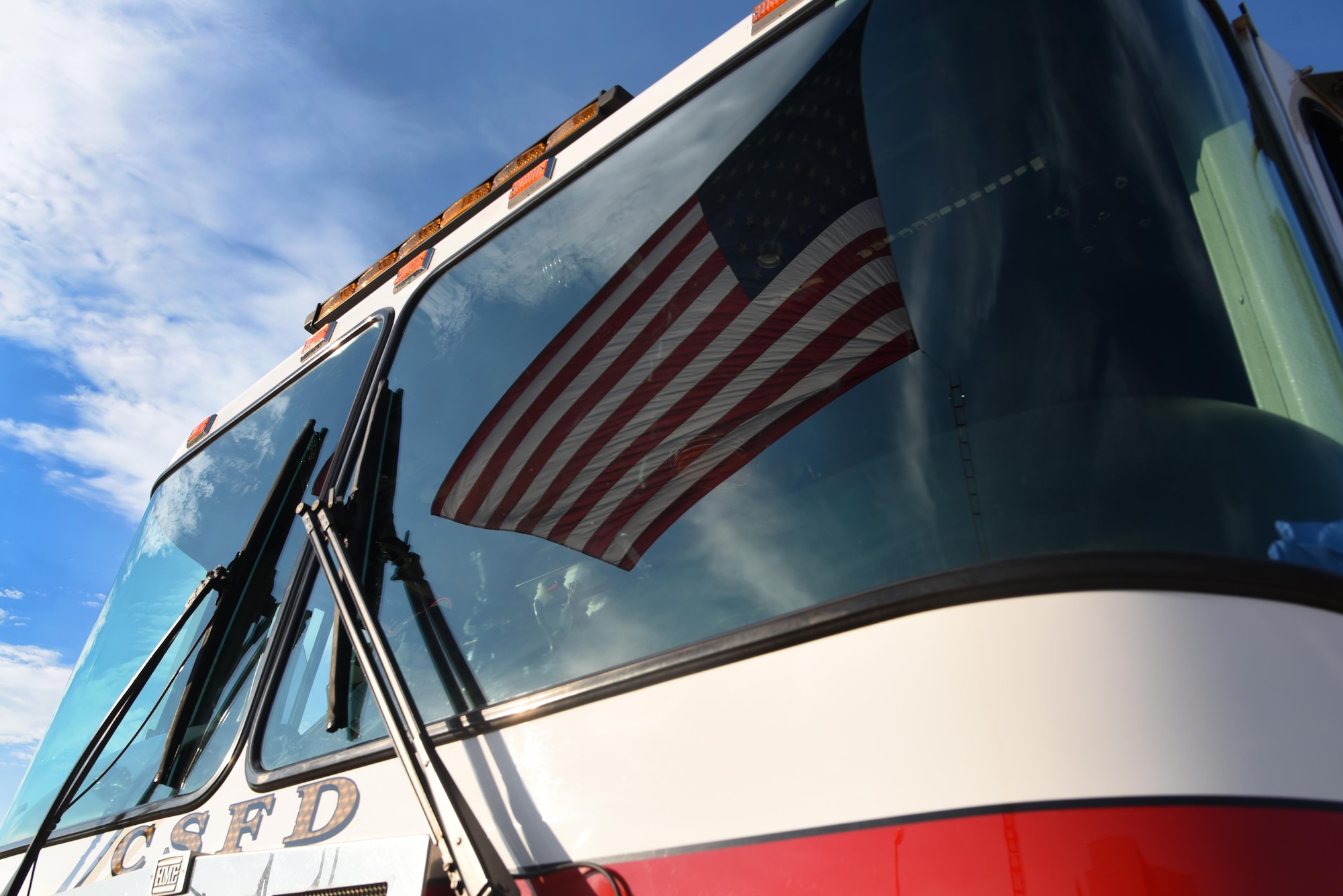 PETERSON AIR FORCE BASE, Colo. -  A reflection of the American Flag bounces off the windshield of a fire engine assigned to the Colorado Springs Fire Department during the 9/11 Remembrance Ceremony at Peterson Air Force Base, Colo., Sept. 11, 2016. The ceremony paid respect to the lives lost in the terrorist attacks of 9/11 with the ringing of the “four fives,” a salute volley, presentation of wreaths and the playing of taps. (U.S. Air Force photo by Airman 1st Class Dennis Hoffman)