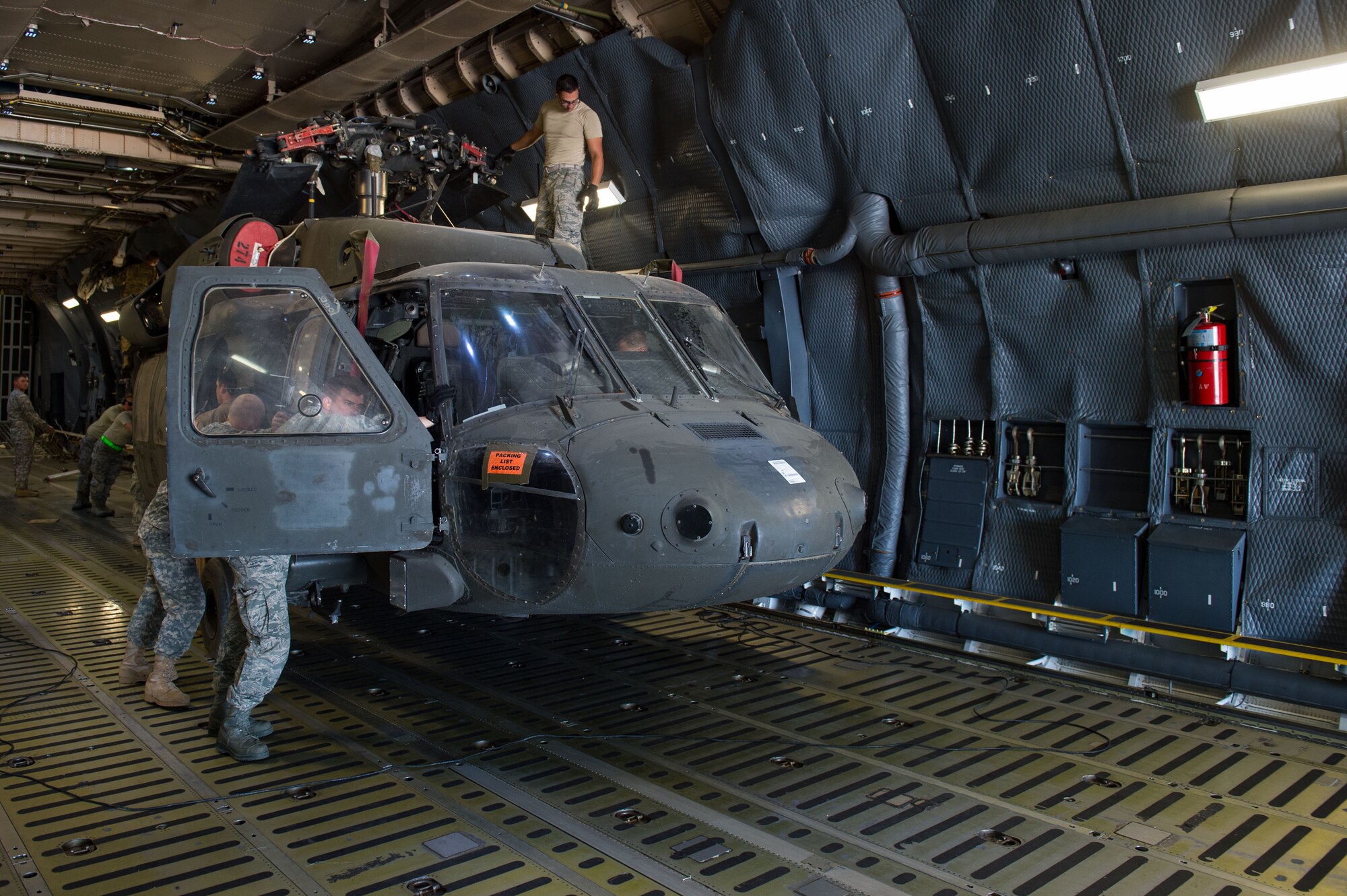 Airmen assigned to the 921st Contingency Response Squadron assist Soldiers assigned to the 3rd Battalion, 4th Aviation Regiment, offload UH-60 Black Hawk helicopters from a C-5 Galaxy at the Fort Carson Air Terminal, Colorado, Sept. 11, 2016. The Soldiers returned from a nine month deployment to Afghanistan. The 921st CRS Airmen were in Colorado participating in Exercise Cerberus Strike 16-02. (U.S. Air Force photo by Master Sgt. Joseph Swafford)