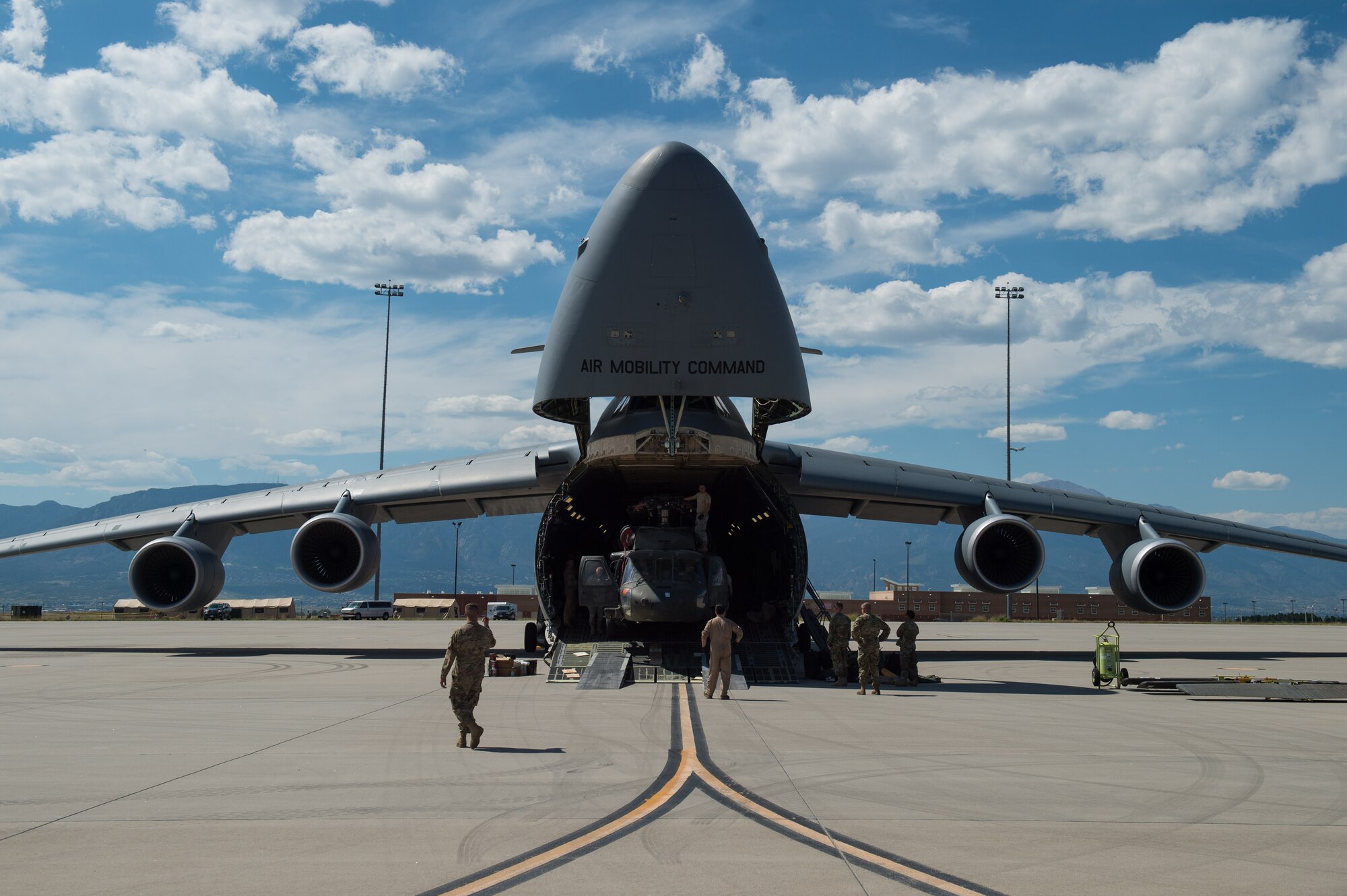 Airmen assigned to the 921st Contingency Response Squadron assist Soldiers assigned to the 3rd Battalion, 4th Aviation Regiment, offload UH-60 Black Hawk helicopters from a C-5 Galaxy at the Fort Carson Air Terminal, Colorado, Sept. 11, 2016. The Soldiers returned from a nine month deployment to Afghanistan. The 921st CRS Airmen were in Colorado participating in Exercise Cerberus Strike 16-02. (U.S. Air Force photo by Master Sgt. Joseph Swafford)