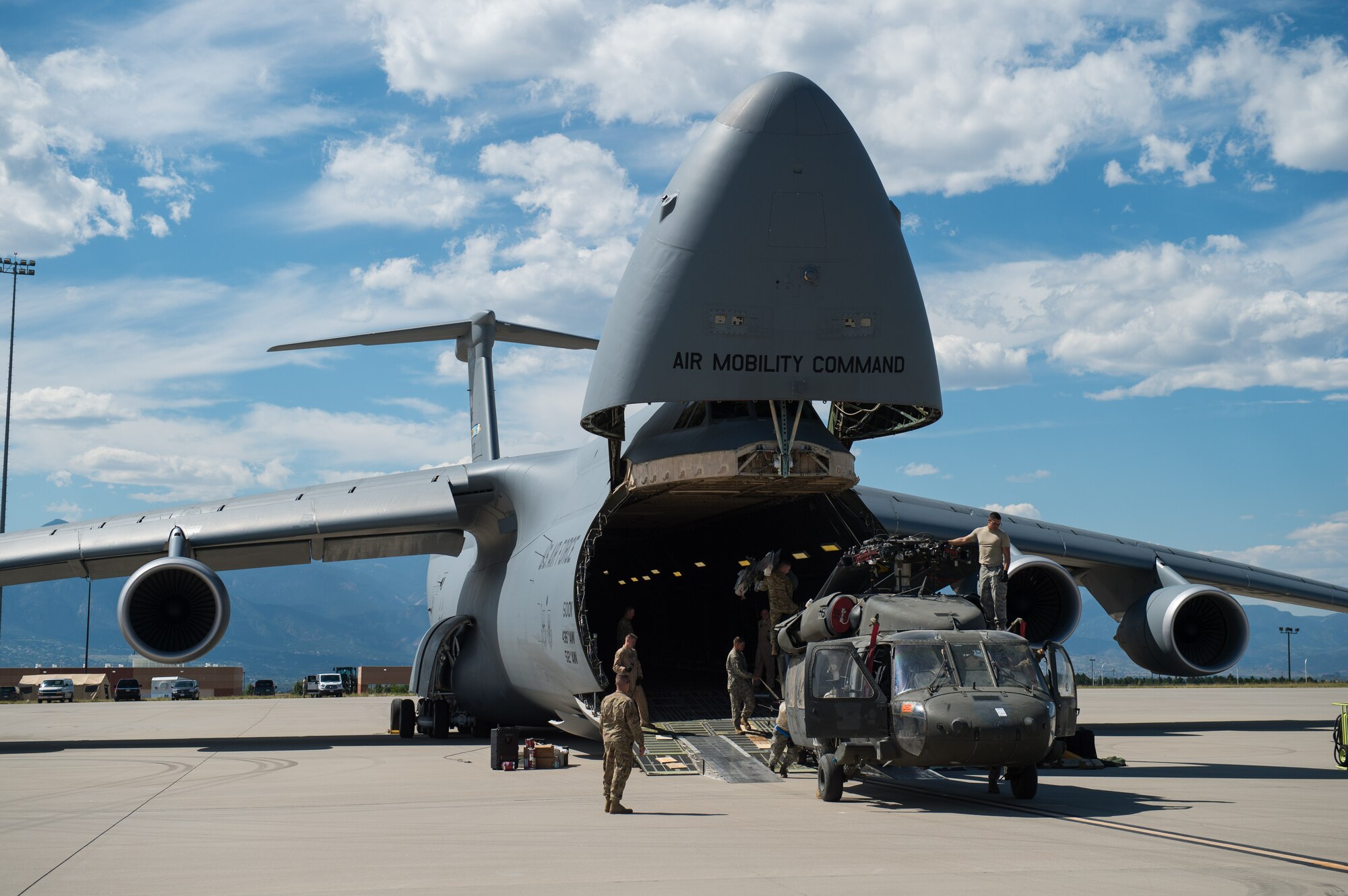 Airmen assigned to the 921st Contingency Response Squadron assist Soldiers assigned to the 3rd Battalion, 4th Aviation Regiment, offload UH-60 Black Hawk helicopters from a C-5 Galaxy at the Fort Carson Air Terminal, Colorado, Sept. 11, 2016. The Soldiers returned from a nine month deployment to Afghanistan. The 921st CRS Airmen were in Colorado participating in Exercise Cerberus Strike 16-02. (U.S. Air Force photo by Master Sgt. Joseph Swafford)