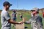 Brig. Gen. Christine Burckle, Utah Air National Guard Commander, presents a personal coin to Kevin Williams, brother of fallen Green Beret Sgt. 1st Class Matthew McClintock, who was killed saving an Airman teammate on Jan. 5 in Afghanistan. Burckle gave remarks at a fitness event on Sept. 10 in Park City, Utah, honoring McClintock, who was awarded the Silver Star for his actions in combat. McClintock was part of the 19th Special Forces Group, which is headquartered in Utah. 