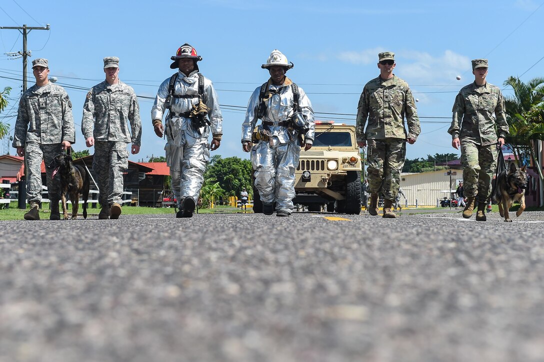 Members of Joint Task Force-Bravo’s Joint Security Forces, Medical Element and Fire Emergency Services march together during a silent parade held in honor of the emergency services personnel who lost their lives during the terrorist attacks of Sept. 11, 2001, before the start of the 9/11 remembrance ceremony at Soto Cano Air Base, Honduras, Sept. 9, 2016. More than 200 service members met in the JSF compound and marched in the silent parade to the 612th Air Base Squadron's fire department.