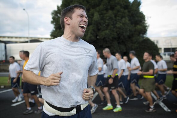 Air Force Capt. Mike Bosack, US Forces, Japan deputy chief for government relations, belts out cadence during the USFJ Command 5K Run at Yokota Air Base, Japan, Sept. 9, 2016. Over 100 service member participated in the run, which concluded with the retirement of the old USFJ colors and the unveiling of the new USFJ colors. (U.S. Air Force photo by Yasuo Osakabe/Released) 