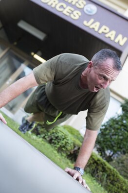 Maj. Gen. Charles Chiarotti, US Forces, Japan commander, leads exercises after the USFJ Command 5K Run at Yokota Air Base, Japan, Sept. 9, 2016. Over 100 service member participated in the run, which concluded with the retirement of the old USFJ colors and the unveiling of the new USFJ colors. (U.S. Air Force photo by Yasuo Osakabe/Released)