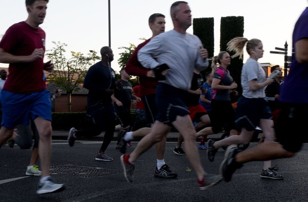 Team Mildenhall members run past the 9/11 memorial during the Patriot Day 5K Sept. 9, 2016, on RAF Mildenhall, England. The event was held in remembrance of the victims and first responders who lost their lives Sept. 11, 2001. (U.S. Air Force photo by Airman 1st Class Tenley Long) 