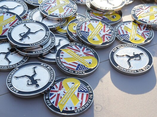 Sept. 11 remembrance coins rest on a table during the Patriot Day 5K Sept. 9, 2016, on RAF Mildenhall, England.  All participants received a coin for doing their part in the event. (U.S. Air Force photo by Airman 1st Class Tenley Long)