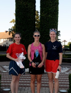 Stephanie Lundeby, Team Mildenhall spouse, middle, U.S. Air Force Lt. Jenee Christensen, 100th Civil Engineering officer in charge, right, and U.S. Air Force Capt. Alycia Hackenburg, 100th Air Refueling Wing senior intelligence officer, left, receive the awards for the best time in the female class following the Patriot Day 5K Sept. 9, 2016, on RAF Mildenhall, England. The event was held in remembrance of the victims and first responders who lost their lives Sept. 11, 2001. (U.S. Air Force photo by Airman 1st Class Tenley Long)
