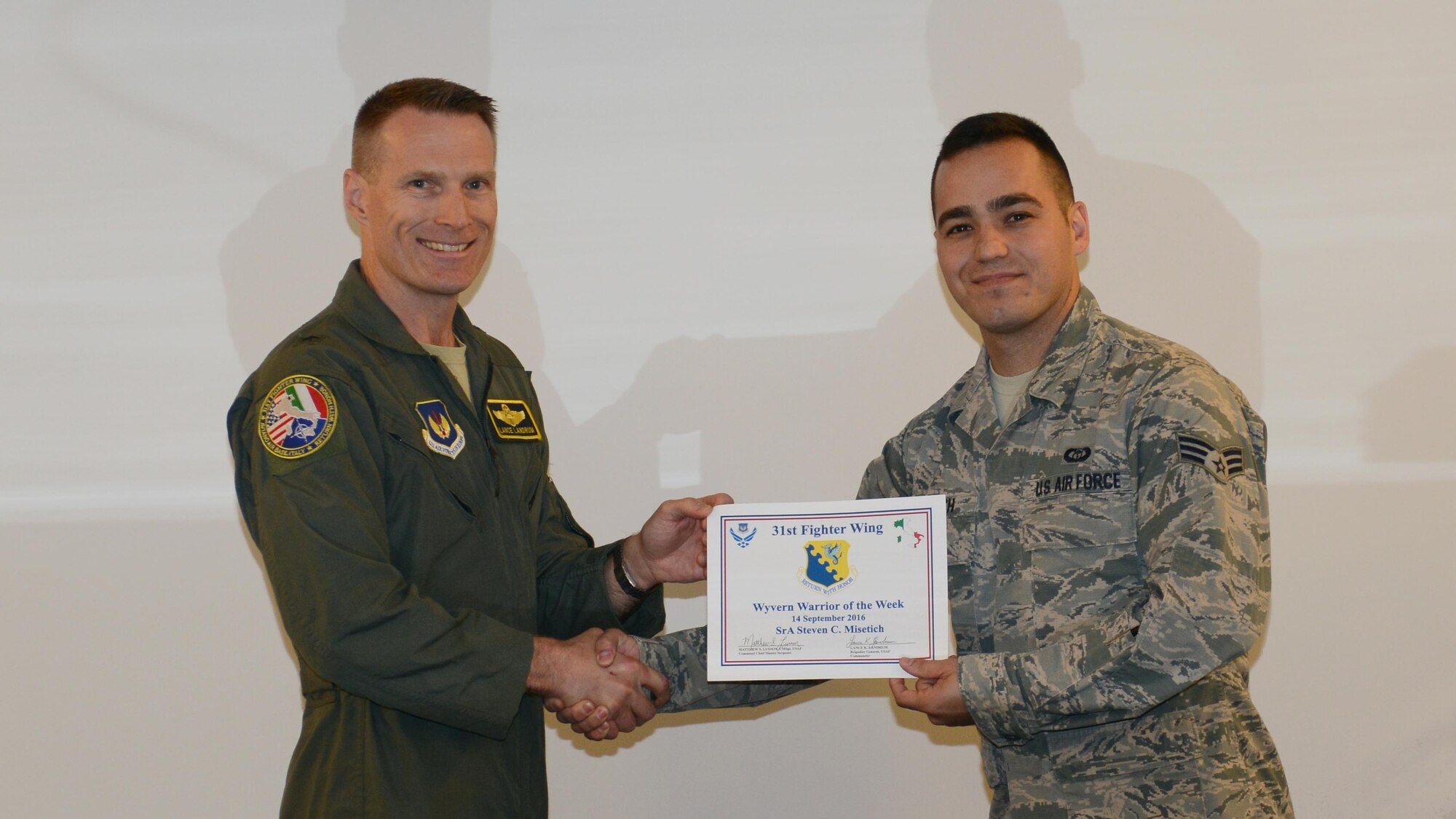 Brig. Gen. Lance Landrum, 31st Fighter Wing commander, names Senior Airman Steven Misetich, 31st Operations Support Squadron weather journeyman, the “Wyvern Warrior of the Week” at Aviano Air Base, Italy on Sept. 14, 2016. Misetich was recognized for his performance in a recent joint exercise and exemplifying the Air Force core value. (U.S. Air Force photo by Staff Sgt. Andrew M. Satran/Released)