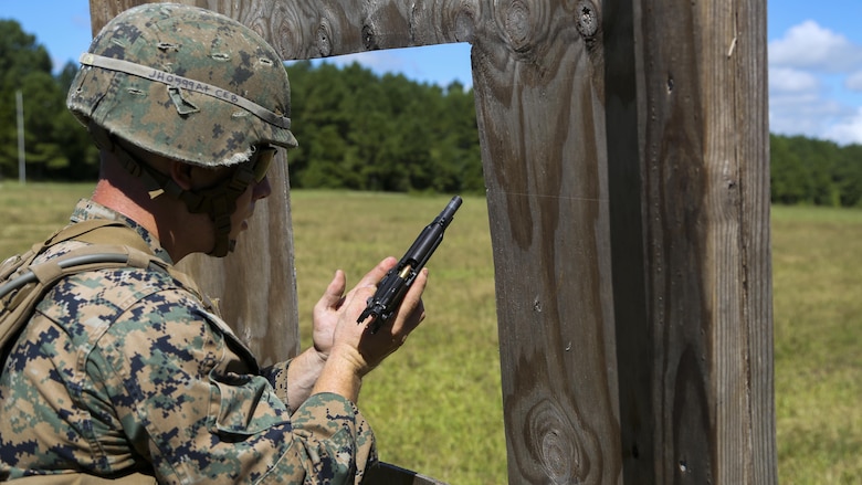 Cpl. Joshua Hodel, Stone Bay target shed noncommissioned officer in charge, conducts a speed reload with the M9 service pistol during a 3-gun shooting competition coordinated by the Combat Marksmanship Trainer Course at Stone Bay on Marine Corps Base Camp Lejeune, N.C., Sept. 1, 2016. The competition enabled CMT students to become familiar with how to set up and run a range and range personnel were also able to hone their marksmanship skills.