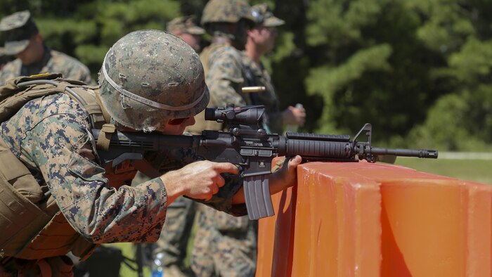 Cpl. Joshua Hodel, Stone Bay target shed noncommissioned officer in charge, fires an M4 service rifle in a 3-gun shooting competition coordinated by the Combat Marksmanship Trainer Course at Stone Bay on Marine Corps Base Camp Lejeune, N.C., Sept. 1, 2016. The competition enabled CMT students to become familiar with how to set up and run a range and range personnel were also able to hone their marksmanship skills.