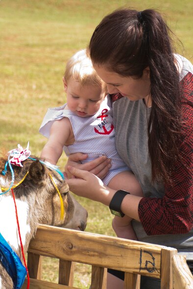 U.S. Air Force Reserve Staff Sgt. Emily Clark, education and training manager, 913th Force Support Squadron, and her son Emerson visit the petting zoo at the 913th Airlift Group's Annual Family Day at Little Rock Air Force Base, Ark., Sept. 10, 2016. Children and adults of all ages interacted with a large number of animals at the family celebration. (U.S. Air Force photo by Master Sgt. Jeff Walston/Released) 