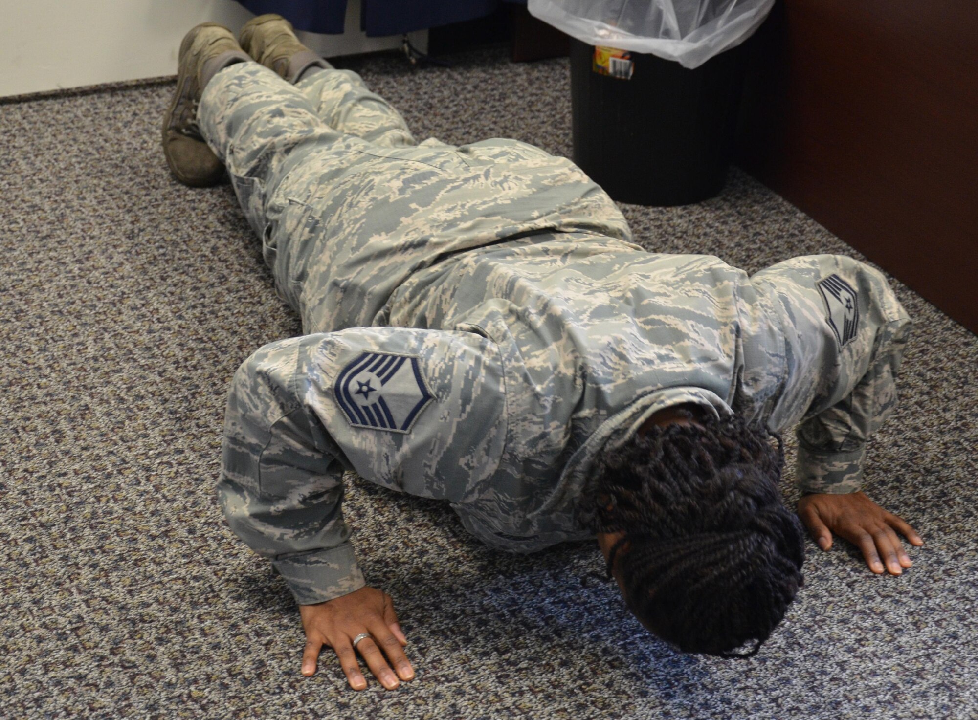 Master Sgt. Altrameise Myers, a knowledge management specialist at the 920th Communications Flight, does 22 pushups in her office at Patrick Air Force Base, Fla., Sept. 12, 2016. The 22 Pushup Challenge emerged to raise awareness about the 22 veterans who die by suicide on average each day, according to a Department of Veterans Affairs report. (U.S. Air Force photo by 1st Lt. Anna-Marie Wyant)