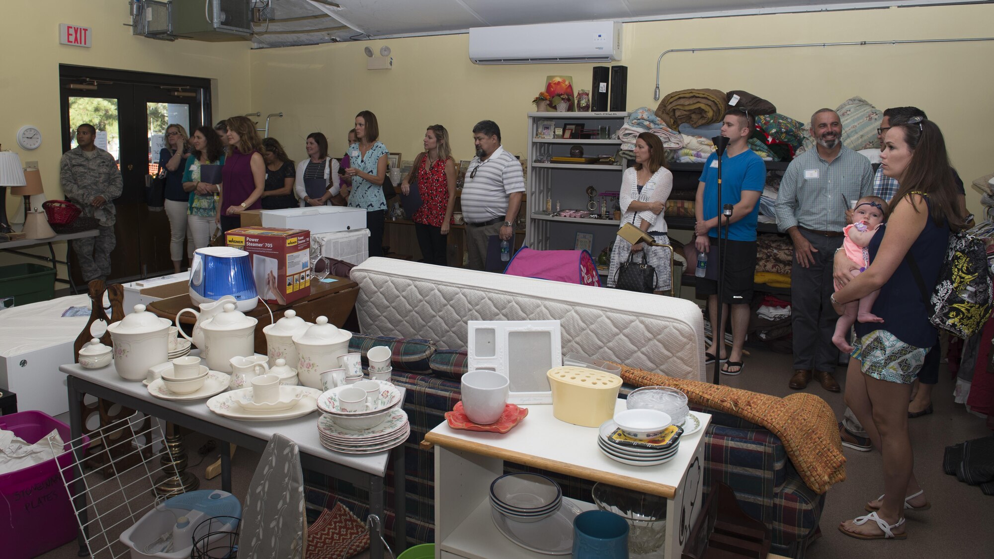 Team Dover spouses tour the Airman’s Attic during a spouses’ tour Sept. 7, 2016, on Dover Air Force Base, Del. This first of its kind spouses’ tour was comprised of 16 Team Dover spouses. (U.S. Air Force photo by Senior Airman Zachary Cacicia)