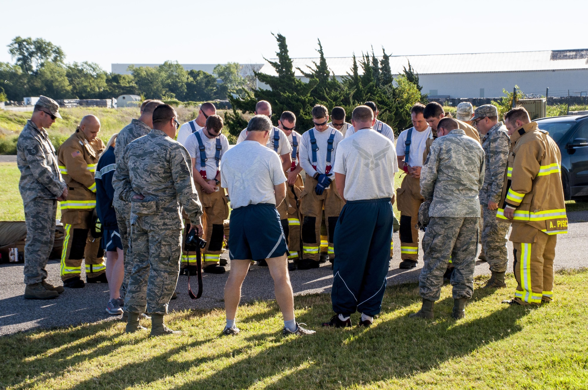 Okie firefighters from the 507th Civil Engineer Squadron and other Reservists from the 507th Air Refueling Wing pray before beginning their 7th annual fire climb Sept. 11, 2016, at Tinker Air Force Base, Okla. To remember the victims and heroes who perished 15 years ago, Reservists climb up and down the fire-training tower to complete the 18 laps within 56 minutes, the amount of time it took the South Tower of the World Trade Center to collapse. (U.S. Air Force photo/Master Sgt. Grady Epperly)
