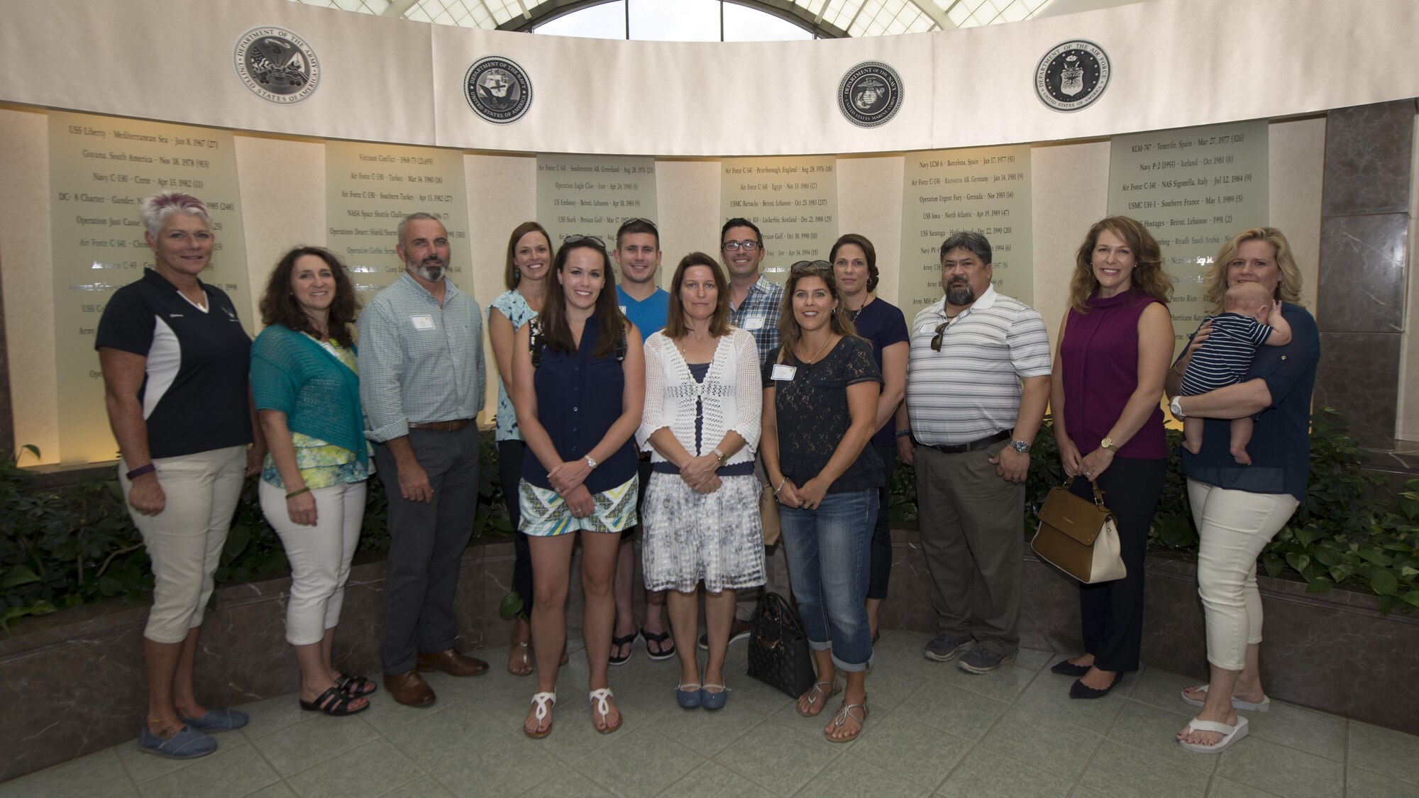 Team Dover spouses pose for a group photo during a spouses’ tour Sept. 7, 2016, inside the Air Force Mortuary Affairs Operations on Dover Air Force Base, Del. A goal of the tour was to help facilitate comradery amongst Team Dover spouses. (U.S. Air Force photo by Senior Airman Zachary Cacicia)