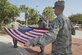 (From left to right) Joint Base Charleston Honor Guard members Airman 1st Class Court Brennan, Senior Airman Cornelius Grant and Airman 1st Class Alexander Klimek begin folding the United States flag during the Patriot Day retreat ceremony at Joint Base Charleston, South Carolina, Sept. 9, 2016. Patriot Day is a day of remembrance for those who lost their lives in the terrorist attacks on Sept. 11, 2001. 