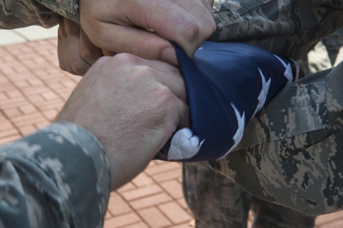 Joint Base Charleston honor guard members fold an American flag during the Patriot Day retreat ceremony at Joint Base Charleston, South Carolina, Sept. 9, 2016. Patriot Day is a day of remembrance for those who lost their lives in the terrorist attacks on Sept. 11, 2001.