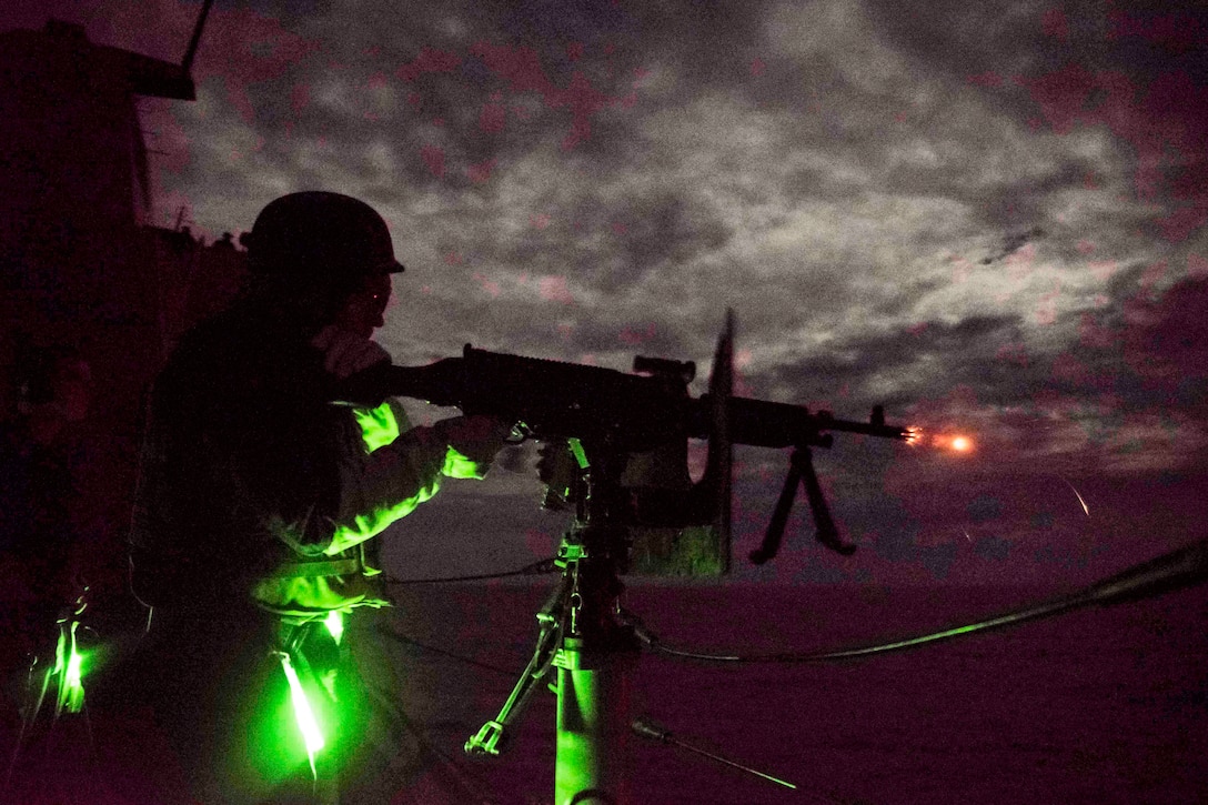 Navy Petty Officer 2nd Class Tanner McCaskell fires an M240B machine gun aboard the USS Green Bay in the Pacific Ocean, Sept. 12, 2016. The Green Bay is operating in the U.S. 7th Fleet area of responsibility to support security and stability in the Indo-Asia-Pacific region. Navy photo by Petty Officer 1st Class Chris Williamson