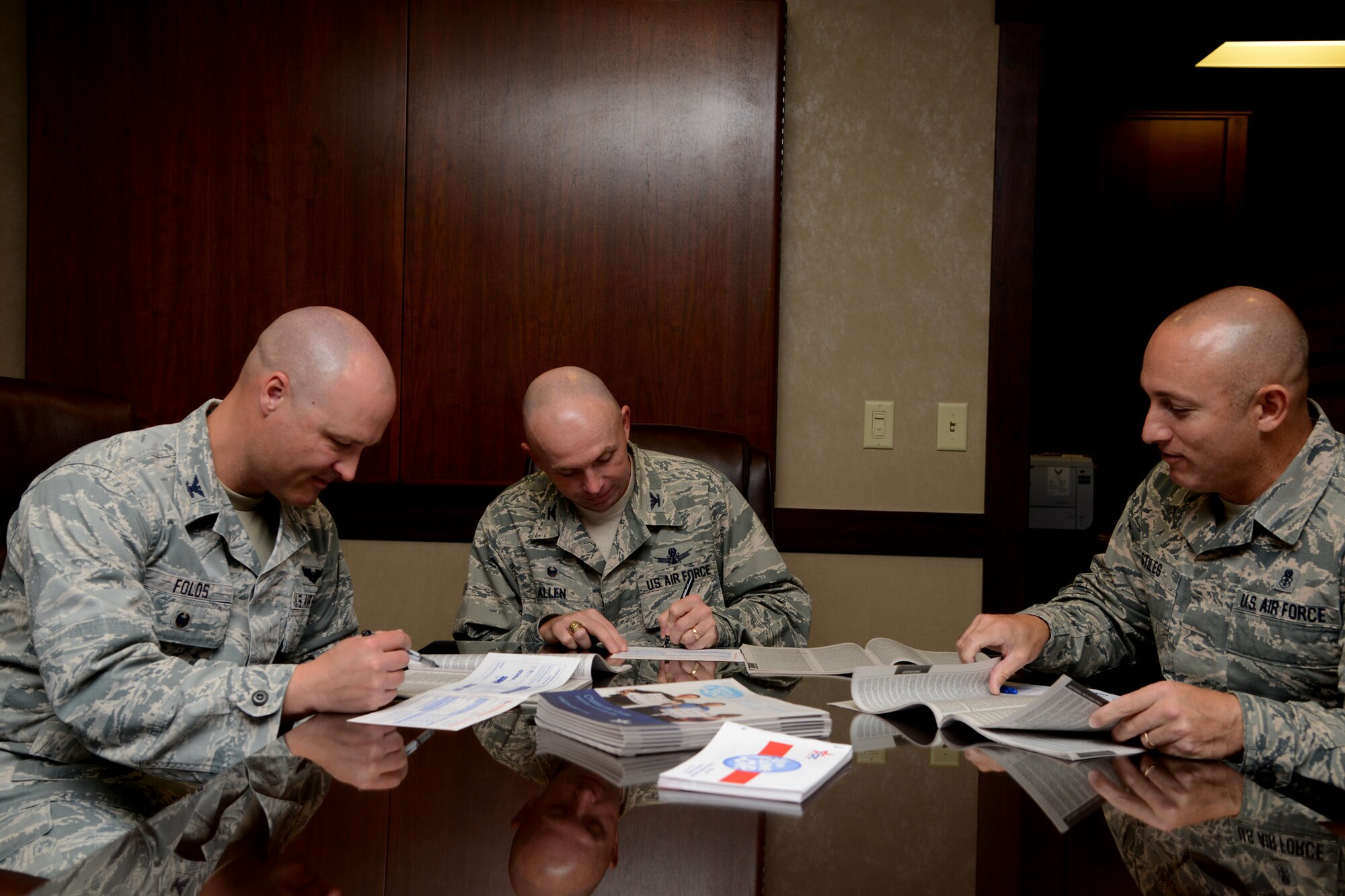 From left to right, Col. Jay Folds, 341st Missile Wing deputy commander; Col. Ronald Allen, 341st MW commander; and Chief Master Sgt. Thomas Stiles, 341st MW command chief, choose the charities they wish to donate to Sept. 13, 2016, at Malmstrom Air Force Base, Mont., for the Combined Federal Campaign. Malmstrom’s CFC will begin with a kick off celebration Sept. 28, 2016, at the Grizzly Bend. (U.S. Air Force photo/Staff Sgt. Delia Marchick)