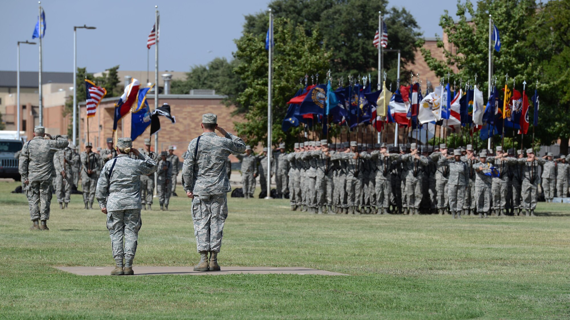 Airmen at Sheppard Air Force Base, Texas, render a salute during the playing of the National Anthem as part of the POW MIA parade, Sept. 9, 2016. Nearly 75 percent of missing Americans are located in the Asia-Pacific area. (U.S. Air Force photo by Senior Airman Kyle E. Gese)