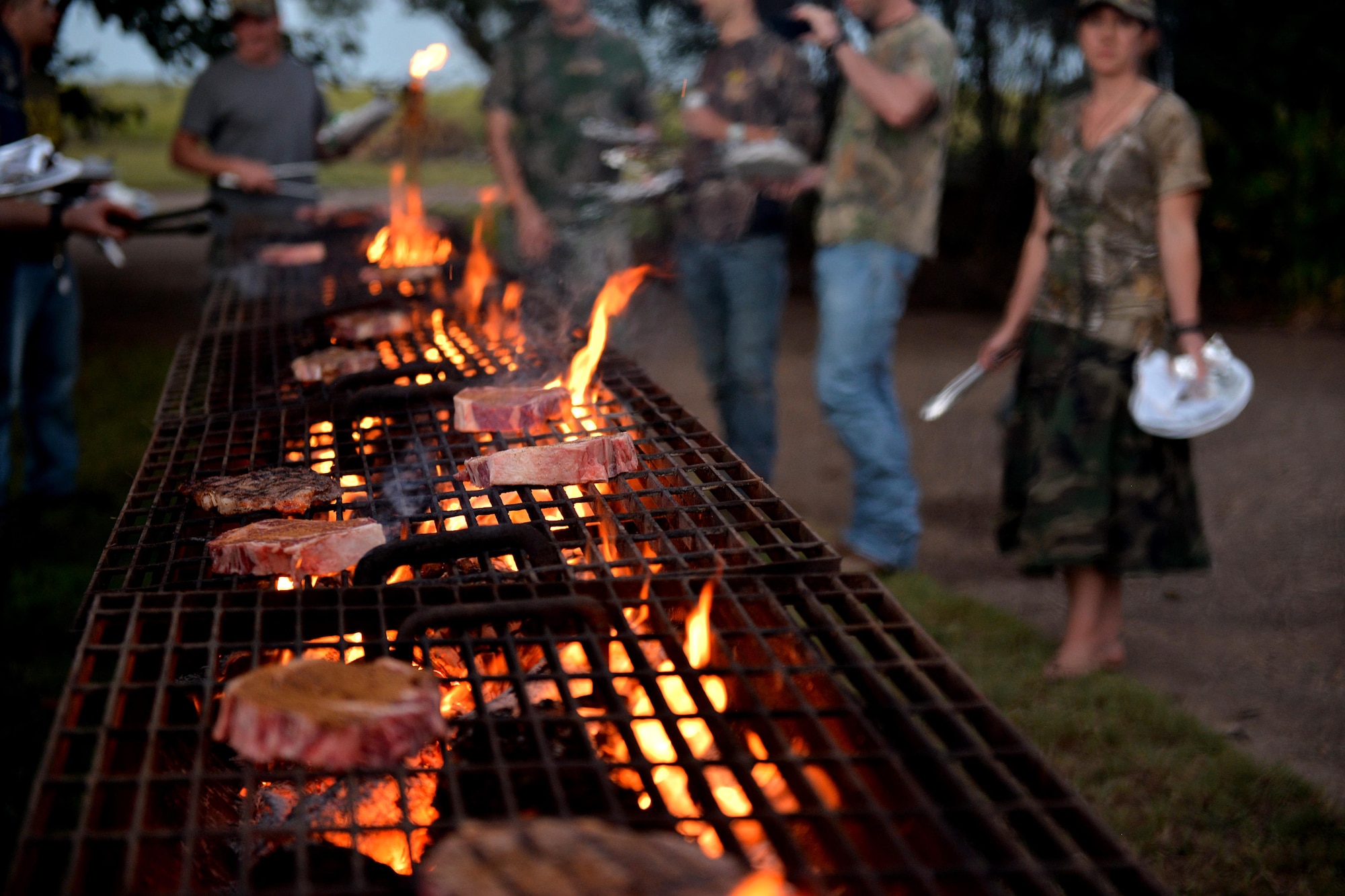 Airmen grill fresh hand-cut steaks after an evening of hunting dove in Henrietta, Texas, Sept. 10, 2016. Birdwell and Clark Ranch hosted the 12th Annual Clay County Dove Salute and invited nearly 175 Airmen from Sheppard Air Force Base, Texas, to hunt through the evening and stay for a steak dinner held at the ranch. (U.S. Air Force photo by Senior Airman Kyle E. Gese)