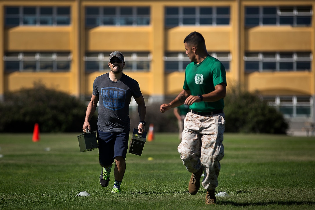 Staff Sgt. Eduardo Haro, a Marine Corps senior drill instructor, motivates Andy Streit, an English teacher at Meadowdale High School in Lynnwood, Wash., while Streit performs a Combat Fitness Test during an Educators Workshop at Marine Corps Recruit San Diego, Aug. 16, 2016. The mission of the Educators Workshop is to inform, demonstrate and build relationships while providing educators and community influencers with firsthand knowledge of the Marine Corps recruiting process, entry level training, job opportunities and educational benefits available to Marines. Haro is from West Wendover, Nev. (U.S. Marine Corps photo by Staff Sgt. Reece Lodder)