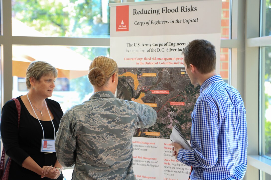 Joe Reed (right), U.S. Army Corps of Engineers, Baltimore District, Levee Safety Program manager, and Stacey Underwood (left), USACE, Baltimore District, DC Silver Jackets Program coordinator, discuss high flood risks in our nation's capital and ways the Baltimore District is helping to reduce these risks at the 2016 DC Flood Summit held at Gallaudet University, Washington, Sept. 8, 2016. (U.S. Army photo by David Gray)