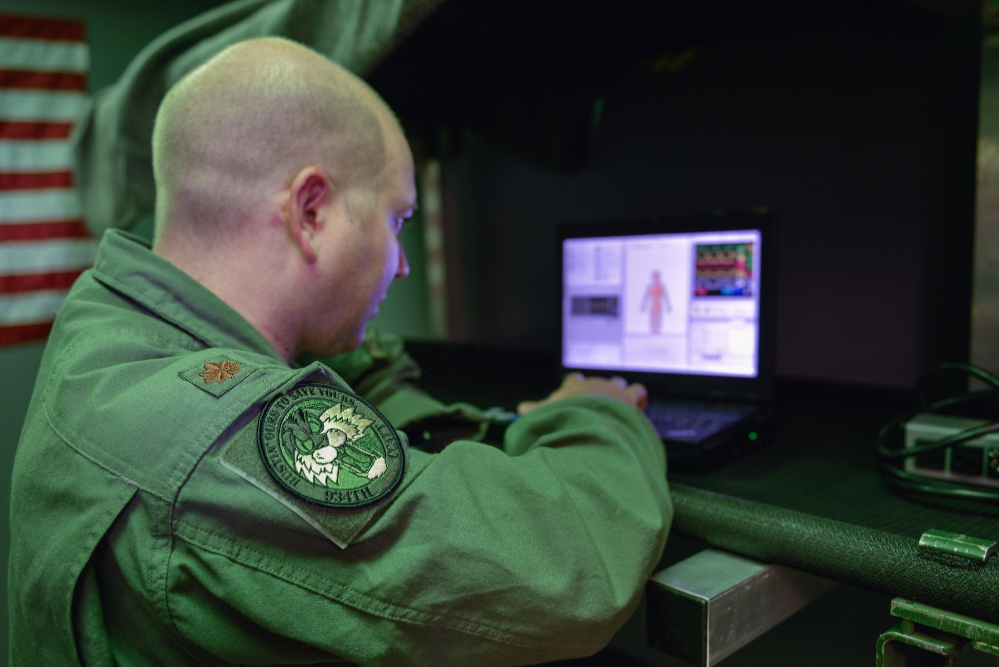 Maj. Jeff Pepin programs scenarios into monitoring equipment for the SimMan 3G.