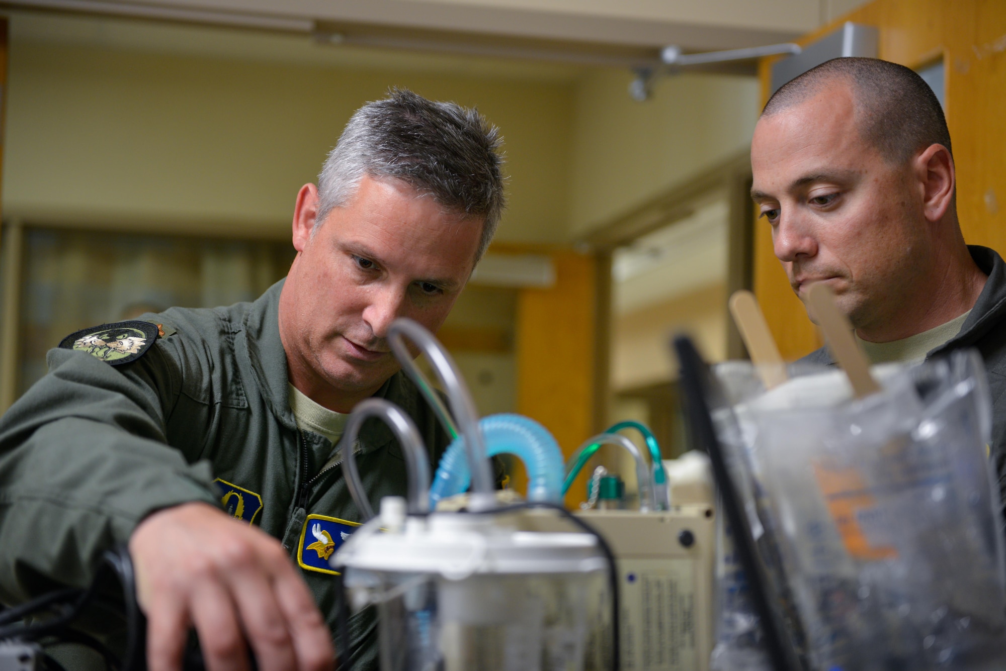 Maj. Steven Murphy (left) and Tech. Sgt. David Pasko set up trauma equipment in preparation for transport.