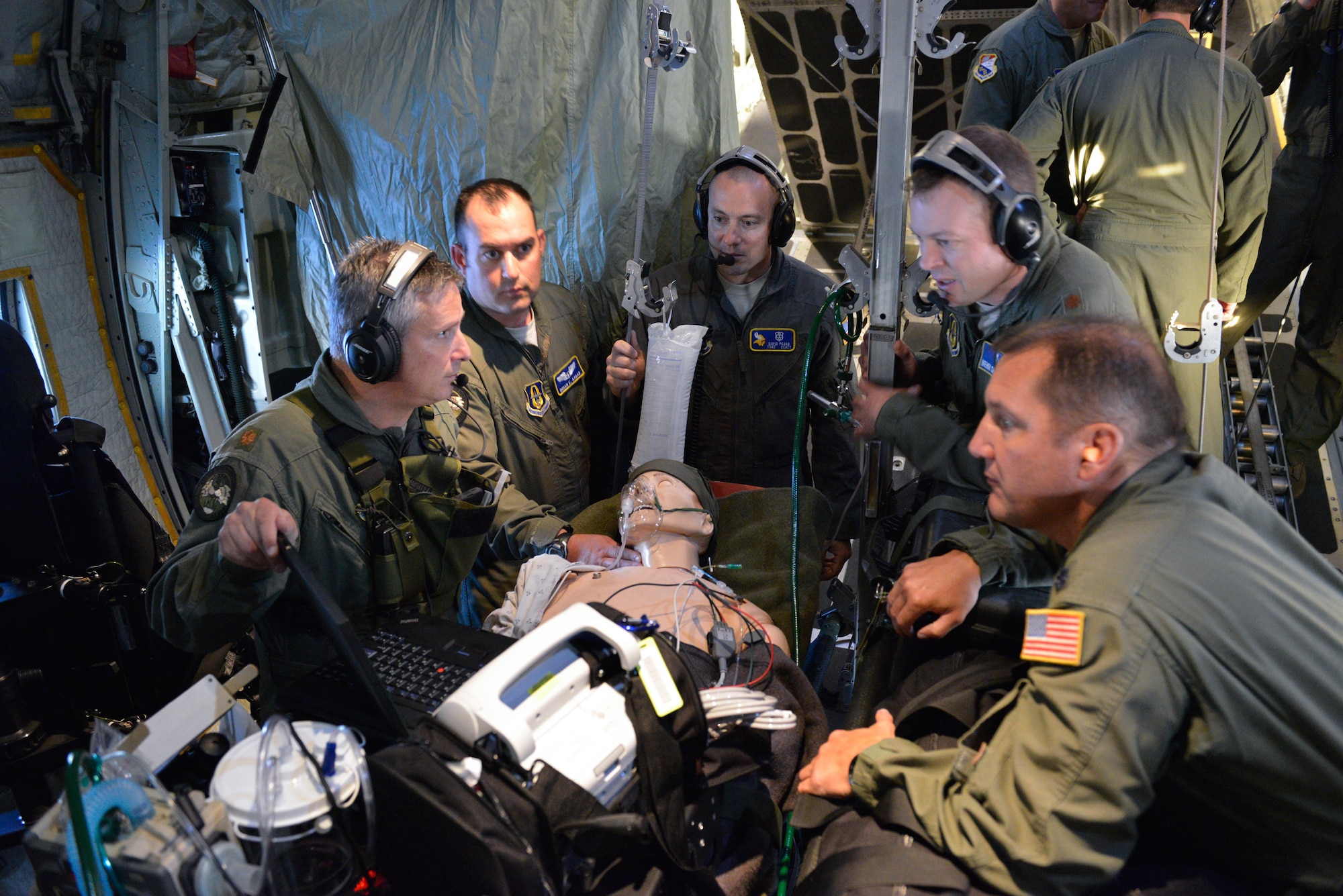 934th CCATT members discuss treatment options for a 'patient' transported aboard a C-130.
