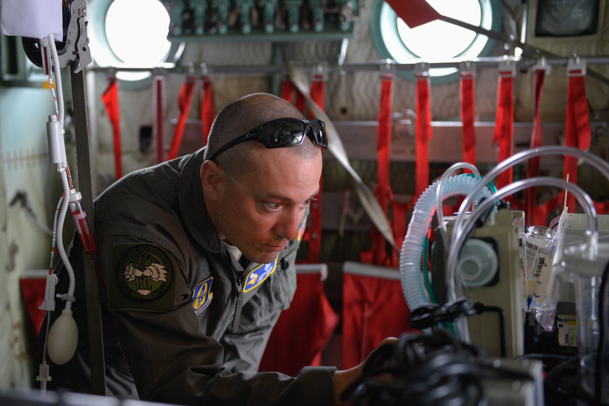 Tech. Sgt. David Pasko, 934th CCATT member, adjusts respiratory control equipment while transporting a 'patient' aboard a C-130.
