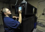 Keri Goff, theater manager, prepares the digital movie projector for a trial run at Joint Base San Antonio-Randolph Fleenor Auditorium Sept. 7, 2016. The theater is scheduled to have its grand reopening Sept. 17, 2016.  