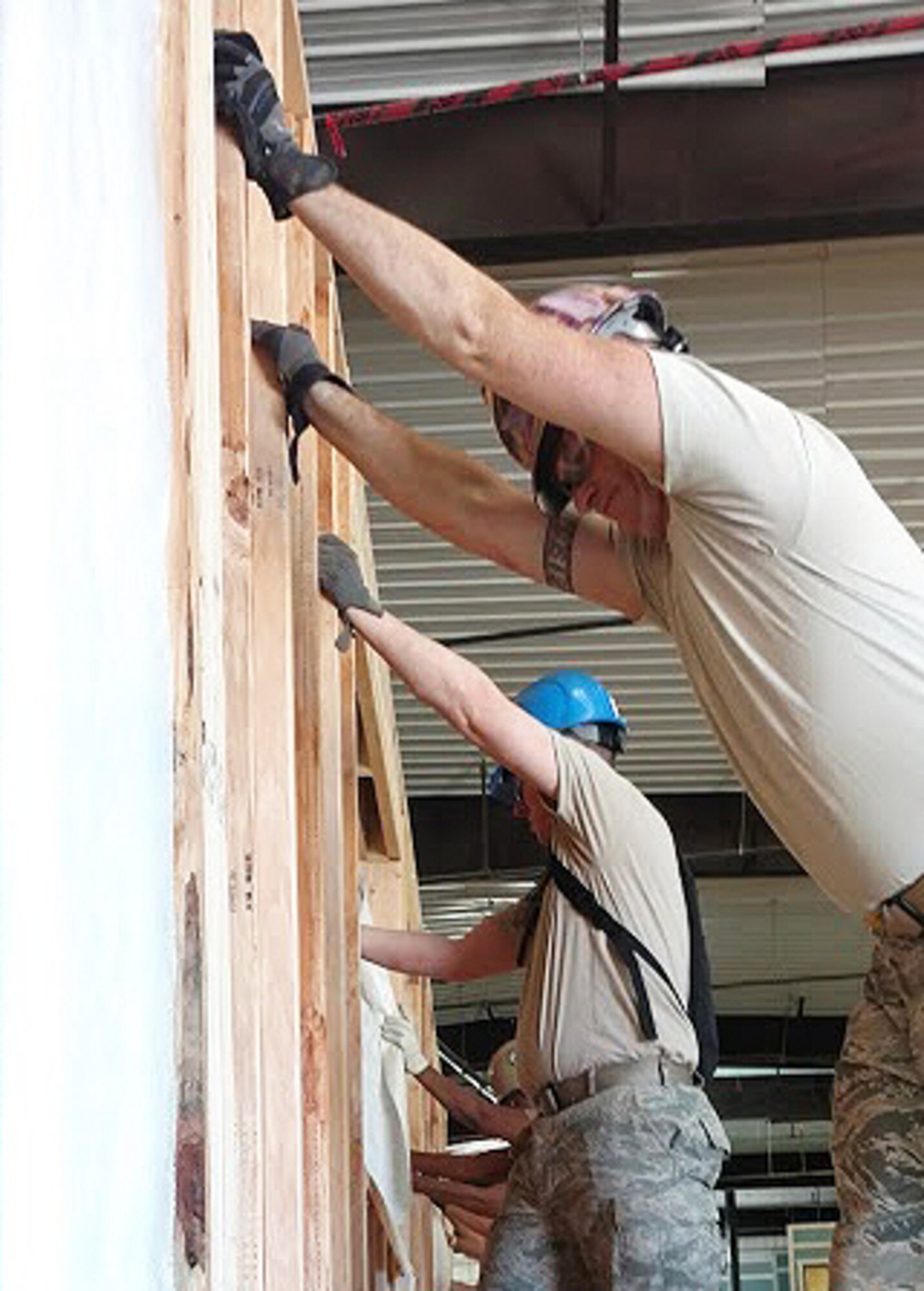 944th Civil Engineering Squadron Airmen and Navy servicemen work together to distribute cement into stem wall forms Jul 18 during Operation Footprint in Gallup, NM. (Courtesy photo)