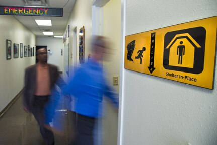 Members of the 502nd Civil Engineering Squadron, Emergency Management Flight enter their office shelter in-place location during a simulated emergency Sep. 7, 2016. September is National Preparedness Month which gives the opportunity to remind Department of Defense personnel and their families to be prepared at all times to respond quickly to disasters and emergencies.  