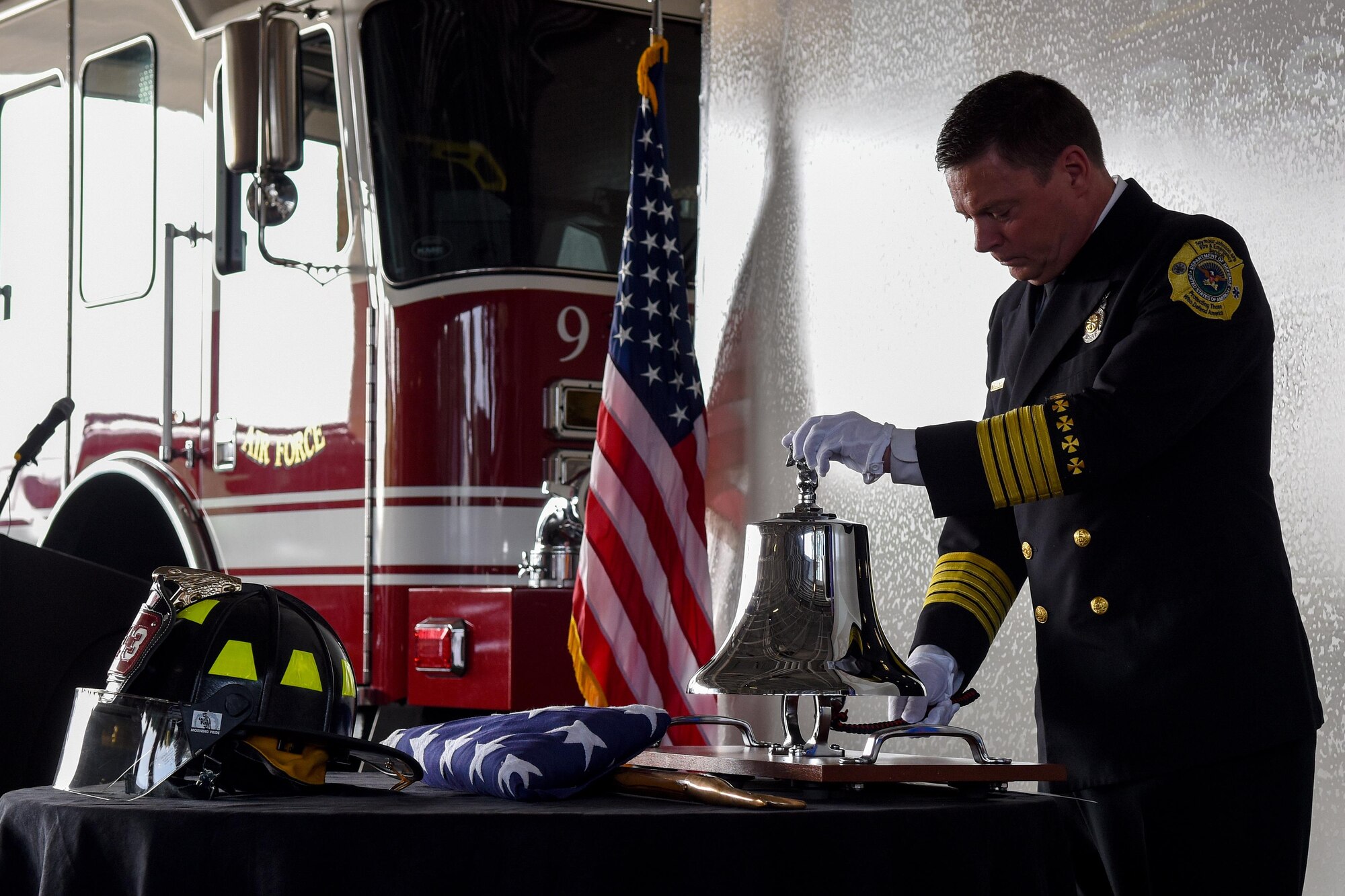 Sean Quinby, 4th Civil Engineer Squadron fire chief, rings a bell during the 9/11 Remembrance ceremony, Sept. 11, 2016, at Seymour Johnson Air Force Base, North Carolina. Quinby rang the bell nine times, signifying the end of duty for the first responders lost during the attacks on 9/11. (U.S. Air Force photo by Airman Shawna L. Keyes)