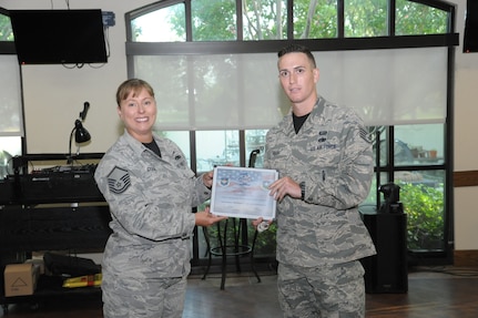Master Sgt. Jennifer Cook (left), 1st Manpower Requirement Squadron first sergeant, presents Staff Sgt. James Hash, 1st MRS manpower analyst, with the Diamond Sharp Award Sept. 9 at Joint Base San Antonio-Randolph. The Diamond Sharp Award recognizes Airmen who have actively demonstrated their commitment to the Air Force values or have gone above and beyond in helping others.   