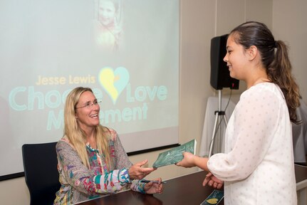 Scarlett Lewis, Founder of the Jesse Lewis Choose Love Movement and author of Nurturing Healing Love: a Mother’s Journey of Hope and Forgiveness, performs a book signing for members of Joint Base San Antonio Sept. 10 at the Chapel Center. Lewis started the Jesse Lewis Choose Love Movement in tribute to her son, Jesse, who was a victim in the Sandy Hook Elementary School shooting in 2012. 