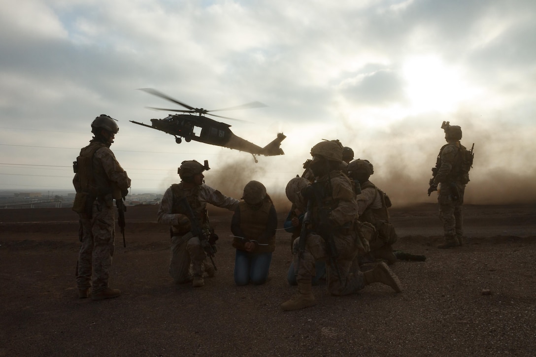 Chile and U.S. Special Forces wait for a U.S. Army UH-60 Blackhawk to evacuate two simulated hostages July 22, 2016 during a training rescue operation as part of exercise Southern Star in Antofagasta, Chile. USSF assigned to Special Operations Command South conducted simulated operations under the command and control of a Chile and U.S. combined operational headquarters. (U.S. Army Photo by Staff Sgt. Osvaldo Equite/Released)