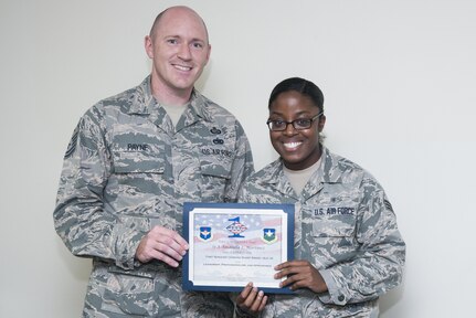 Master Sgt. Robert Payne (left), 359 Medical Group first sergeant, presents Senior Airman Amandla Martinez, 359th Medical Support Squadron personnel and administrative clerk, with the Diamond Sharp Award Sept. 7 at Joint Base San Antonio-Randolph. The Diamond Sharp Award recognizes Airmen who have actively demonstrated their commitment to the Air Force values or have gone above and beyond in helping others.   