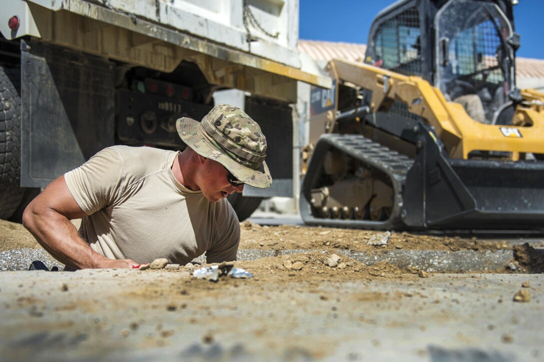 Air Force Staff Sgt. Jacob Skjei digs a hole at a construction site at Bagram Airfield, Afghanistan, Sept. 7, 2016. Skjel is a pavements and equipment technician assigned to the 455th Expeditionary Civil Engineer Squadron. Air Force photo by Senior Airman Justyn M. Freeman