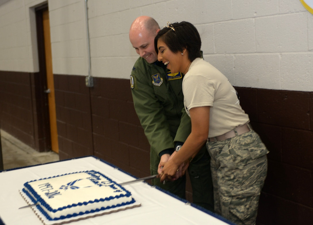 Col. Bradley Cochran, vice commander assigned to the 28th Bomb Wing, and Airman Stacy Acosta, an airfield management apprentice with the 28th Operations Support Squadron, cut cake during the combat dining out at Ellsworth Air Force Base, S.D., Sept. 9, 2016. Acosta, the youngest Airman on base, was bestowed the honor of cutting the cake during the dining out in celebration of the U.S. Air Force’s heritage and 69th birthday. (U.S. Air Force photo by Airman 1st Class Donald C. Knechtel)