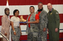 Maj. Eric Ashe, commander of the 28th Communications Squadron, and Chief Master Sgt. William Catts, superintendent of the 28th CS, receive a Golden Boot for best squadron table decorations at Ellsworth Air Force Base, S.D., Sept. 9, 2016. During the dining out, Airmen were authorized alternative uniform wear and encouraged to decorate their units table in an effort to win a “Spirit Award.”(U.S. Air Force photo by Airman 1st Class Donald C. Knechtel)
