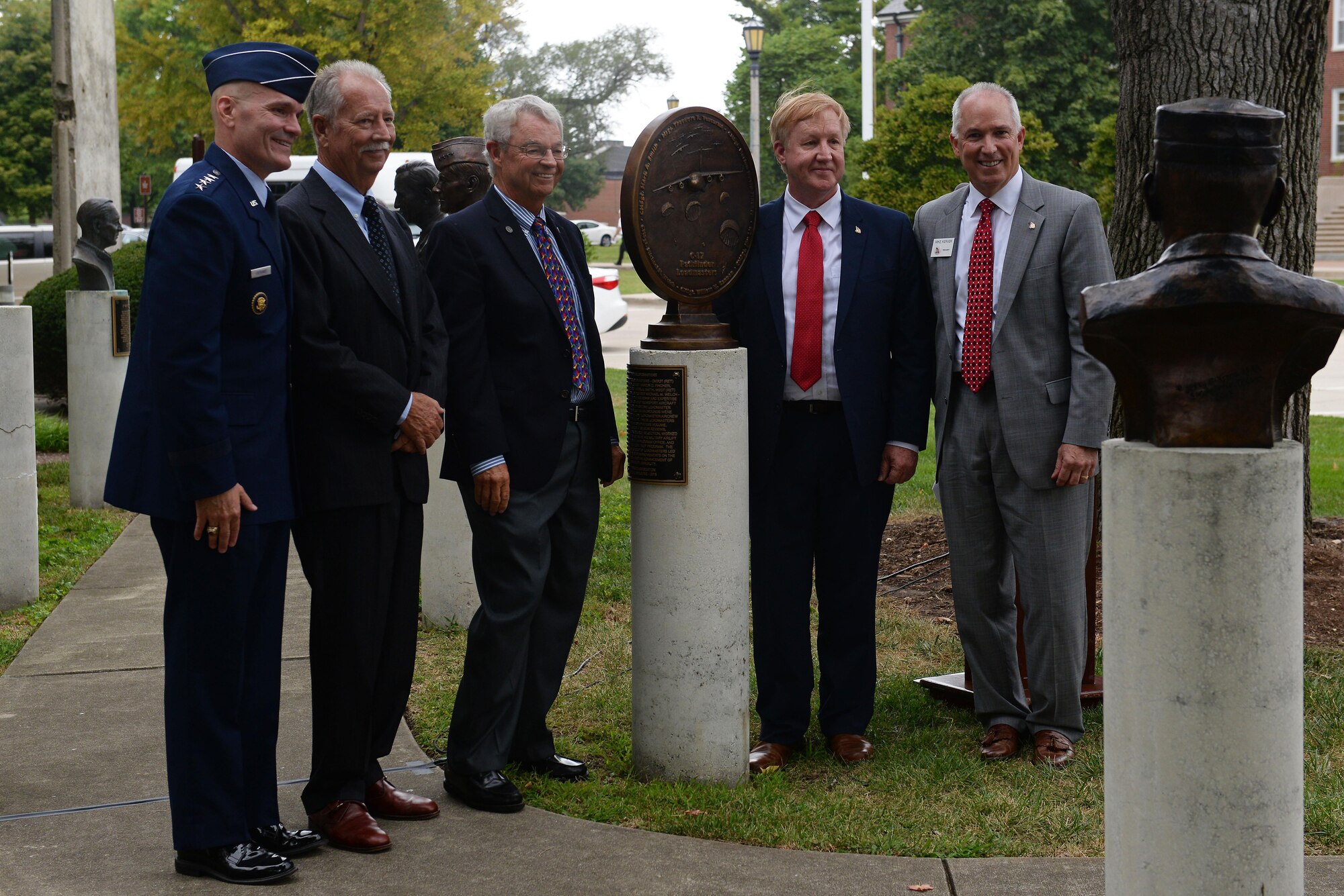 Three of six honorees, called “Pathfinder Loadmasters,” unveil a bronze medallion commemorating their accomplishments in revolutionizing C-17A operations, at Scott Air Force Base, Illinois, Sept. 8, 2016. Gen. Carlton D. Everhart II, Commander, Air Mobility Command and Retired Chief Master Sgt. Mike Kerver, President of the Airlift/Tanker Association, were also there to help honor these individuals. They are listed on the plaque in Mobility Memorial Park: Chief Master Sgt. William (Bill) M. Cannon, deceased, Chief Master Sgt. Marion (Dave) D. Fincher, Chief Master Sgt. (Mike) M. Welch, Chief Master Sgt. James (Jim) Lis, Chief Master Sgt. Mark A. Smith, and Master Sgt. Theodore (Ted) R. Venturini. (U.S. Air Force photo by Senior Airman Erica Fowler)