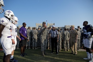 Col. Robert Lyman, Joint Base Charleston commander, performs the coin toss prior to the football game between the Citadel Bulldogs and Furman Paladins as Navy Capt. Robert Hudson, Joint Base Charleston deputy commander (right), looks on Sept. 10, 2016. The pregame festivities also included an aerial demonstration by the Army Golden Knights and a formation of service members from Joint Base Charleston.